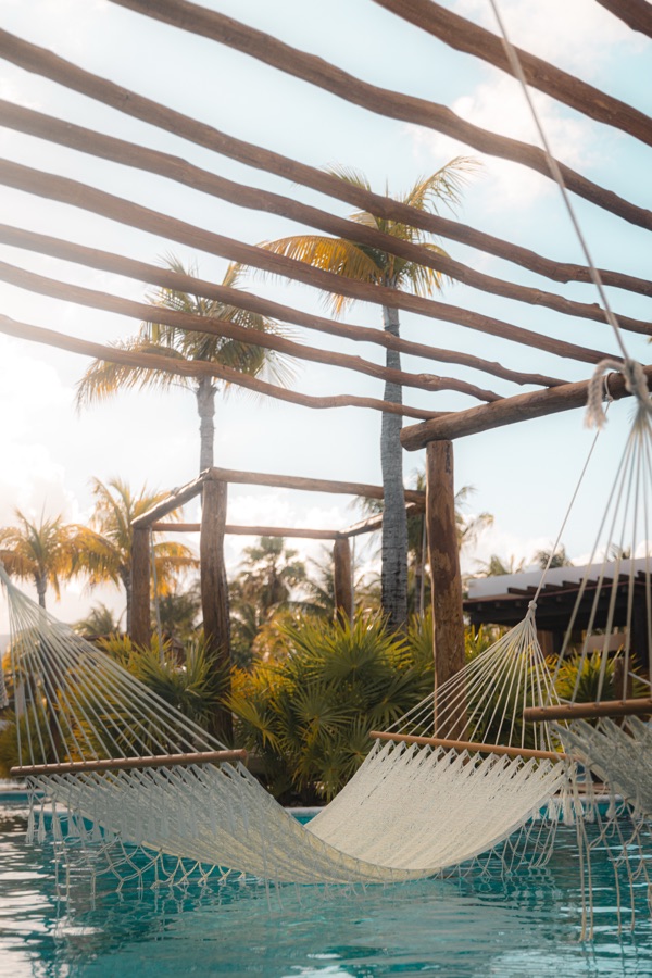 Hammock over a resort pool at golden hour in Cancún